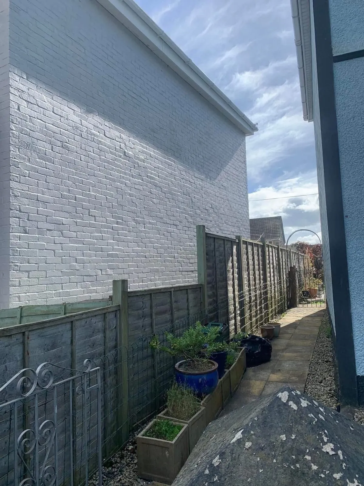 Freshly painted brick wall after preparation and masonry paint in Great Torrington