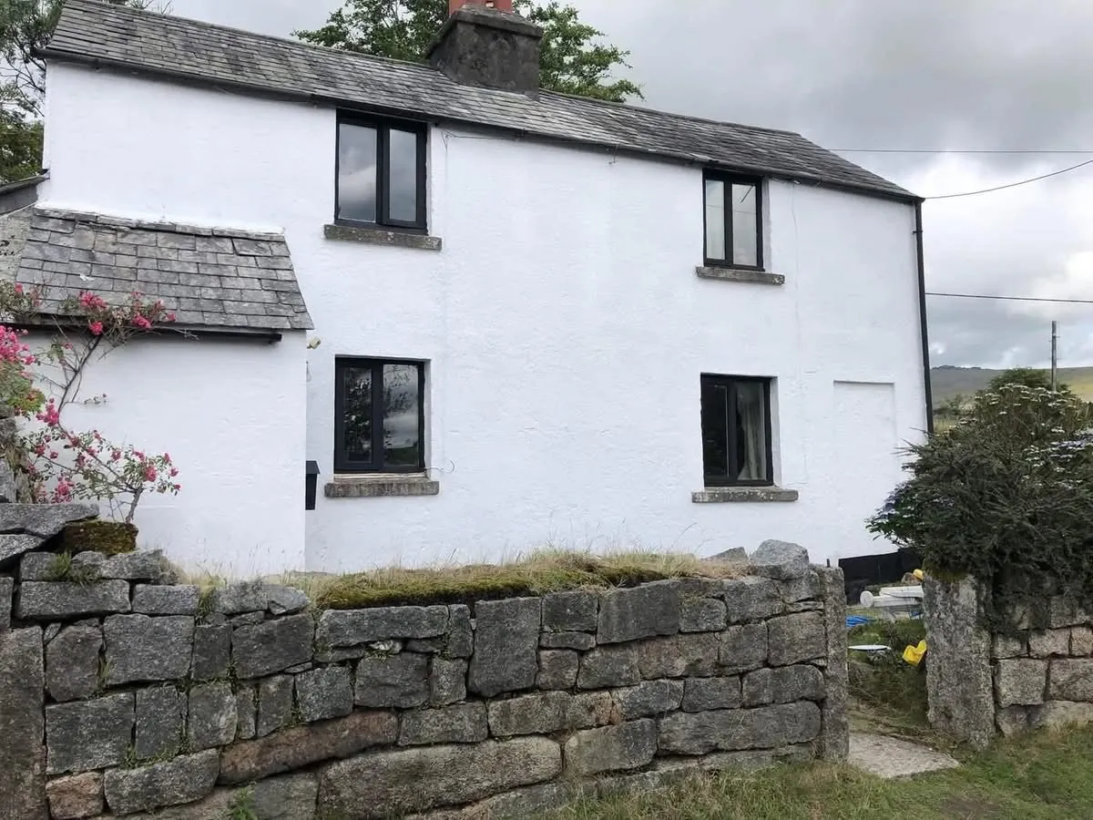 Render repair and exterior repaint of a cottage in Great Torrington